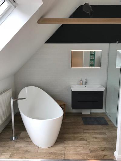 Photo shows loft conversion with modern bathroom suite